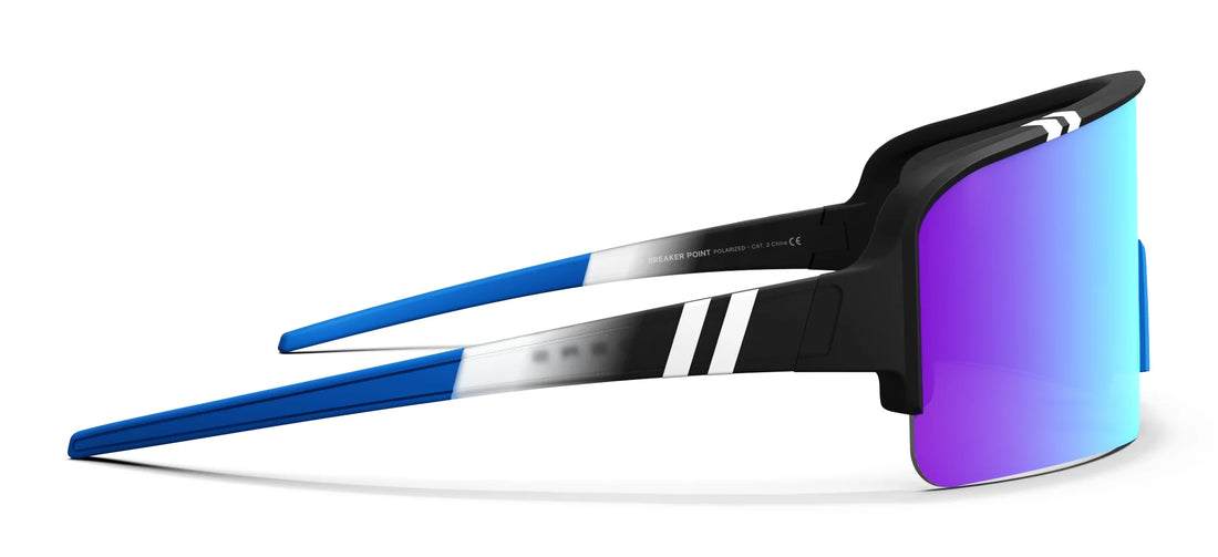 Blenders Eclipse Risk Taker sunglasses with polarized wraparound lens, vivid green color, teal tips, and paint splatter frame.