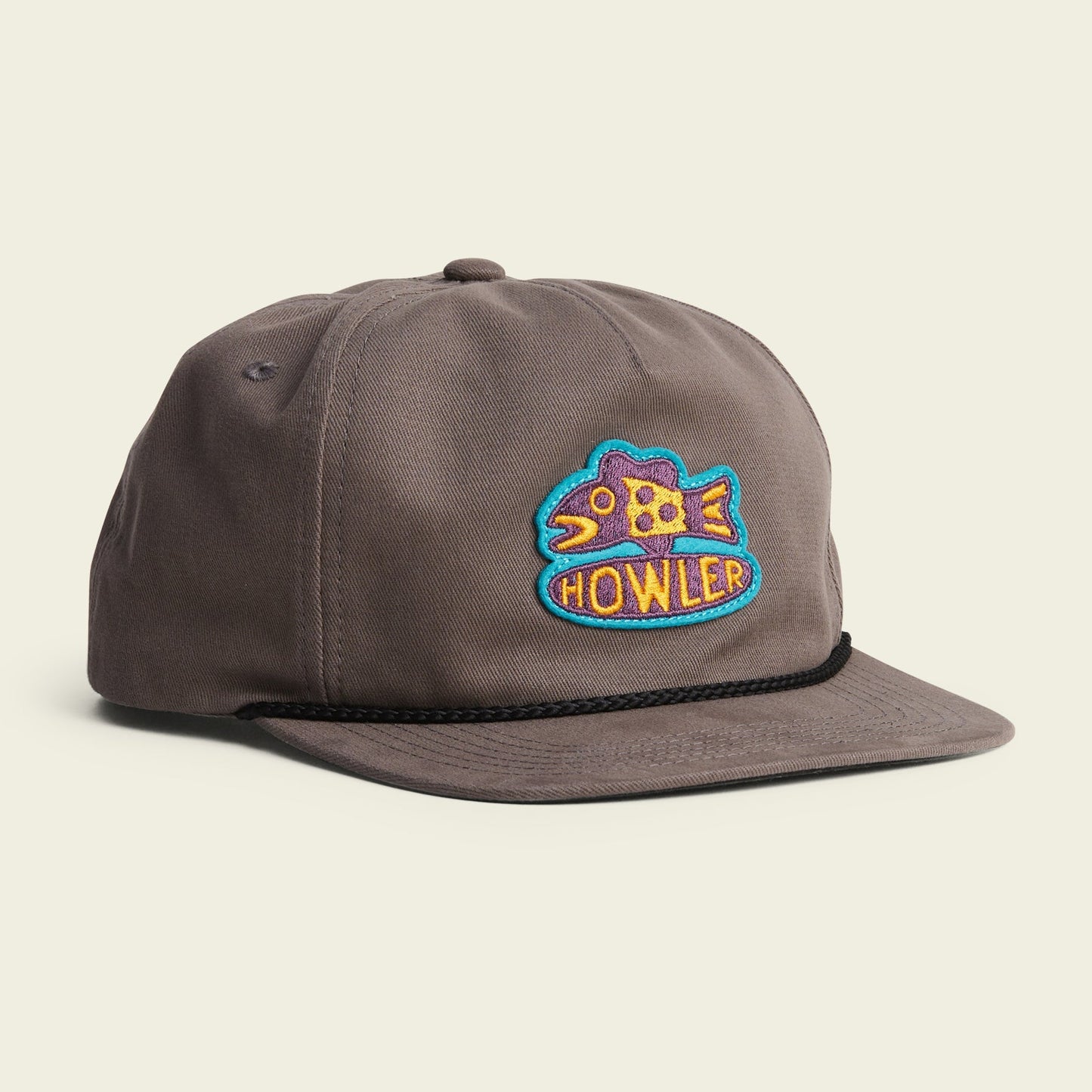 Howler Bros Something Fishy Snapback hat with embroidered fish logo, dark under brim, and adjustable closure.
