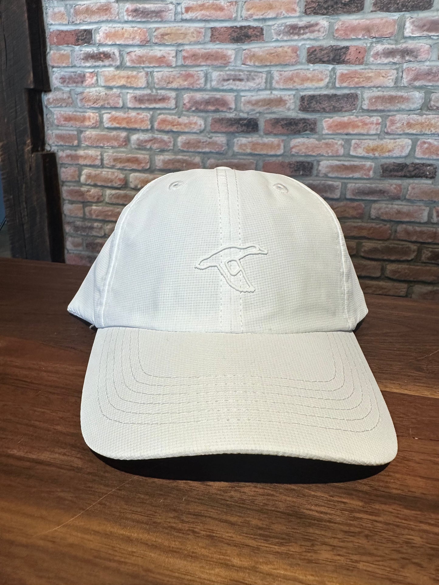 GenTeal white stamped performance hat with breathable fabric and adjustable closure.